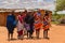 Massai man, wearing traditional blankets, overlooks Serengetti in Tanzania and Kenya