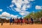 Massai men, wearing traditional blankets, overlooks Serengetti in Tanzania and Kenya in traditional massai village