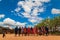 Massai men, wearing traditional blankets, overlooks Serengetti in Tanzania and Kenya in traditional massai village