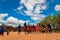 Massai men, wearing traditional blankets, overlooks Serengetti in Tanzania and Kenya in traditional massai village