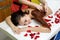 Masseur applying chocolate to woman`s back. Massage in spa salon