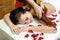 Masseur applying chocolate to woman`s back. Massage in spa salon