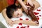 Masseur applying chocolate to woman`s back. Massage in spa salon