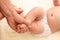 Masseur doing exercise for foot little baby