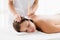 Masseur giving ear candle treatmet to woman