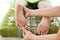 Masseur giving female patient a foot reflexology.