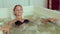 Masseur makes a woman a massage at hydrobath