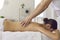 Masseur making acupressure or relaxing massage of back woman