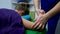 A masseur massages a woman.