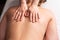 masseur massaging back and shoulder blades of young woman on massage table. Concept of massage spa treatments. Close-up