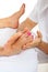 Masseur massaging woman feet