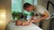 Masseur plays with newborn boy and massages baby legs