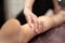 Masseur Providing a Deep Tissue Leg Massage at Spa