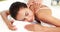 Masseuse giving massage to relax woman