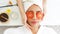 Masseuse masking face with tomato and spa face woman treatment and massage aroma therapy relax