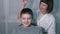 Masseuse Massages the Head of a Child with a Capillary Acupuncture Massager