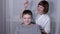 Masseuse Massages the Head of a Child with a Capillary Acupuncture Massager