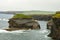 Massive awe-inspiring sea stack created by coastal erosion on Loop Head Peninsula, County Clare, Ireland.