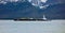 A massive barge arriving at the coastal port of seward