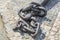 Massive black anchor chain on paving stones