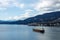 A massive cargo ship navigates under Lions Gate Bridge in Burrard Inlet, with the West Vancouver skyline in the background