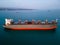 A massive cargo ship wood chips carrier in the sea, aerial view