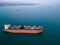 A massive cargo ship wood chips carrier in the sea, aerial view