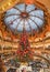Massive Christmas tree decoration with flowers inside Galerie Layfayette shopping mall