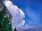 Massive cloud above the house on the blue sky