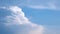 Massive clouds - cumulus congestus or towering cumulus - forming in the blue sky