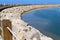 Massive concrete blocks and large stones are laid in a breakwater on the shores of the Mediterranean Sea