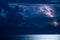 Massive cumulus clouds and lightning over the sea