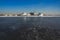 Massive different ship vessels trapped in ice tries to break and leave the bay between the glaciers, icebreaker and carrier vessel