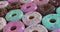 Massive of doughnuts - mix of multicolored sweet donuts with sprinkles. 3d