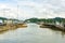 Massive gates opening at the Pedro Miguel locks on the Panama canal. Freighter and tug approaching Centennial bridge in the