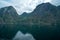 Massive geiranger fjord in norway seen from a cruise ship with light shining through the clouds