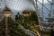 Massive glass dome and elevated walkway above indoor garden at the Orchard at Doha\\\'s Hamad International Airport
