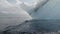 Massive iceberg and waves over the black sand in slow-mo