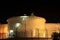 Massive industrial oil tanks at night