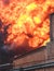 Massive large blaze fire in the city, brick factory building on fire, hell major fire explosion flame blast,  with firefighters