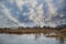 Massive starling murmuration over Somerset wetlands lake landscape in Autumn Winter