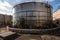 massive steel tank, filled with hot radioactive waste, surrounded by high-tech security system