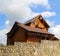 Massive stone wall in front of a two story log private cottage restricts private territory stock photo