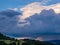 Massive storm clouds in the sky over hilly landscape