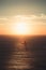 A massive sunset over a lonely rock in the middle of the ocean