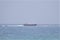 Massive tanker run around on reef against stormy skies