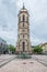 Massive tower of the town church in Balingen and the market fountain well, Germany