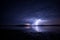 Massive triple lightning over the lake with reflection