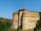 Massive walls and bastions of Khotyn Fortress with fields on the background