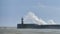 Massive waves crash over harbour wall onto lighthouse during huge storm on English coastline in Newhaven, amazing images showing